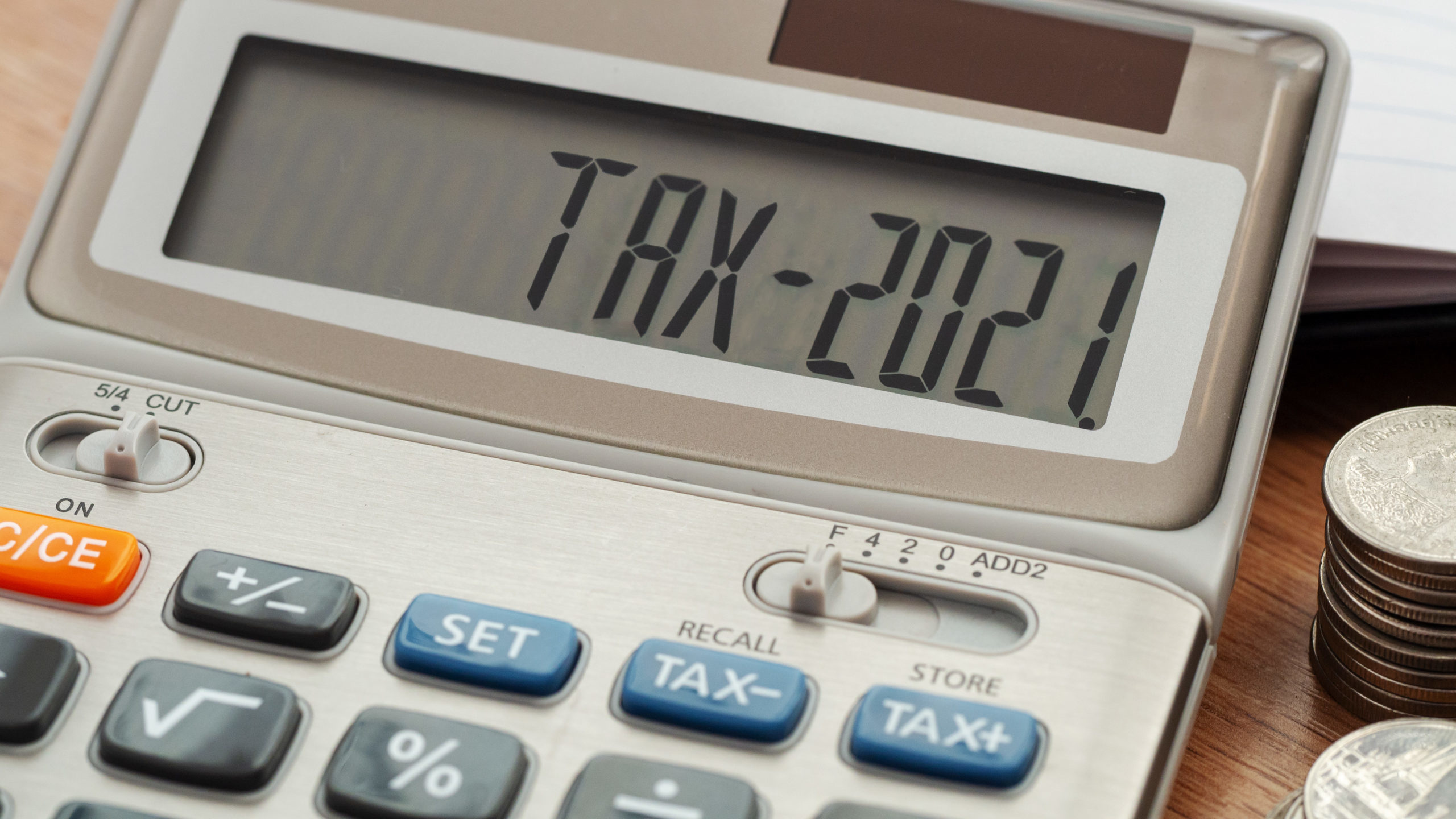 Tax word and 2021 number on calculator. Business and tax concept. Pay tax in 2021 years.